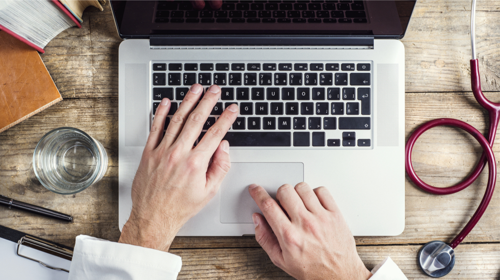 Hands of a man on a laptop