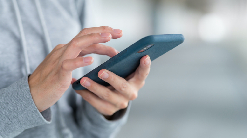 A man using a blue smartphone.