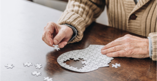 Man putting together a puzzle. 