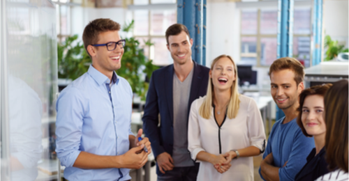 Image of a team laughing and working together. 